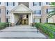 Apartment building entrance with stairs and manicured landscaping at 10202 Fairington Ridge Cir, Lithonia, GA 30038