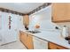 Well-lit kitchen featuring light wood cabinets, white countertop, and a stainless steel double sink at 10202 Fairington Ridge Cir, Lithonia, GA 30038