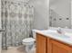 Hall bathroom features single sink vanity, toilet, and tub with neutral patterned curtain at 2012 Ellison Nw Way # 15, Kennesaw, GA 30152