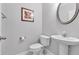 Charming powder room featuring pedestal sink, white tile flooring, and modern toilet at 2012 Ellison Nw Way # 15, Kennesaw, GA 30152