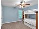 Neutral bedroom features a bunk bed, ceiling fan, and built-in shelving unit at 2012 Ellison Nw Way # 15, Kennesaw, GA 30152