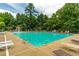 Large community pool with lounge chairs, umbrellas, and a mushroom fountain, creating a refreshing and inviting atmosphere at 2012 Ellison Nw Way # 15, Kennesaw, GA 30152