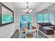 Bright dining area features stylish chandelier, modern wood floors, and easy access to the outdoor deck at 2012 Ellison Nw Way # 15, Kennesaw, GA 30152