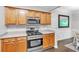 Updated kitchen features stainless steel range and wood cabinets with modern countertops at 2012 Ellison Nw Way # 15, Kennesaw, GA 30152