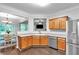 Open kitchen features stainless steel appliances, wood cabinets, and eat-in dining area at 2012 Ellison Nw Way # 15, Kennesaw, GA 30152