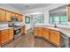 Spacious kitchen features stainless steel appliances and wood cabinets with view into dining area at 2012 Ellison Nw Way # 15, Kennesaw, GA 30152