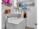 Well-lit laundry area features washer, dryer, and wire shelving for storage at 2012 Ellison Nw Way # 15, Kennesaw, GA 30152