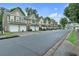 Street view showcasing well-maintained townhomes with garages and ample parking at 2012 Ellison Nw Way # 15, Kennesaw, GA 30152
