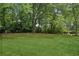 Expansive backyard featuring a well-maintained lawn and mature trees, offering privacy and ample space for recreation at 2074 Hilburn Se Dr, Atlanta, GA 30316