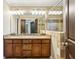 Elegant bathroom featuring a dual sink vanity, a glass-enclosed shower and decorative lights at 2074 Hilburn Se Dr, Atlanta, GA 30316