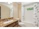 Bright bathroom with a granite vanity, white tiled shower, and decorative dolphin shower curtain at 2074 Hilburn Se Dr, Atlanta, GA 30316