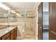 Elegant bathroom featuring a dual sink vanity, a glass-enclosed shower, and neutral tiling at 2074 Hilburn Se Dr, Atlanta, GA 30316