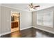Bedroom leading to ensuite bathroom featuring dark hardwood floors and a ceiling fan at 2074 Hilburn Se Dr, Atlanta, GA 30316