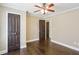 Bedroom with dark hardwood floors, a ceiling fan and a set of closet doors at 2074 Hilburn Se Dr, Atlanta, GA 30316
