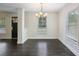 Bright dining room with hardwood floors, elegant chandelier, and lots of natural light at 2074 Hilburn Se Dr, Atlanta, GA 30316