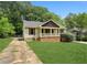 Quaint single-story home featuring a well-maintained lawn and a cozy front porch at 2074 Hilburn Se Dr, Atlanta, GA 30316