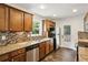 Well-lit kitchen showcasing granite countertops, stainless steel appliances, and wood cabinetry at 2074 Hilburn Se Dr, Atlanta, GA 30316