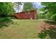 The home features a sloped backyard, mature trees and wooden deck at 2900 Country Nw Ct, Kennesaw, GA 30152