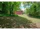 The home features a sloped backyard, mature trees and wooden deck at 2900 Country Nw Ct, Kennesaw, GA 30152