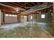 Unfinished basement offers potential with exposed wood beams, concrete floor, and garage door access at 2900 Country Nw Ct, Kennesaw, GA 30152