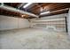 Unfinished basement offers room for storage with exposed beams, concrete floor, and built-in shelving at 2900 Country Nw Ct, Kennesaw, GA 30152
