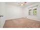 A carpeted bedroom features a window and a ceiling fan at 2900 Country Nw Ct, Kennesaw, GA 30152