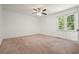 A spacious carpeted bedroom has a ceiling fan and window at 2900 Country Nw Ct, Kennesaw, GA 30152