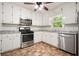 Updated kitchen featuring stainless steel appliances, granite countertops, and white cabinets at 2900 Country Nw Ct, Kennesaw, GA 30152