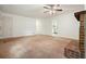 Bright living room with a ceiling fan and brick fireplace ready for cozy nights at 2900 Country Nw Ct, Kennesaw, GA 30152