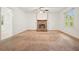 Open living room showcasing a brick fireplace, neutral carpeting, and access to another room at 2900 Country Nw Ct, Kennesaw, GA 30152