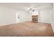 Spacious living room with a brick fireplace, neutral carpeting, and lots of natural light at 2900 Country Nw Ct, Kennesaw, GA 30152