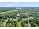 Drone eye view of a Auburn, GA home with its surroundings nestled among mature trees and lush greenery at 483 Glen Terrace Rd, Auburn, GA 30011