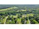 Expansive aerial view of homes nestled among mature trees and lush greenery in a serene Auburn, GA neighborhood at 483 Glen Terrace Rd, Auburn, GA 30011