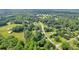 Wide aerial view showcasing a community with houses surrounded by dense, mature trees at 483 Glen Terrace Rd, Auburn, GA 30011