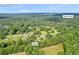 Aerial view of Auburn, GA, neighborhood with Rock Creek, showcasing homes with mature trees at 483 Glen Terrace Rd, Auburn, GA 30011