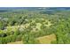 Aerial view showcasing homes nestled among dense, mature trees in a tranquil neighborhood at 483 Glen Terrace Rd, Auburn, GA 30011