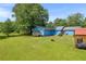 Spacious backyard with lush green lawn, storage sheds, and a peaceful, private setting at 483 Glen Terrace Rd, Auburn, GA 30011