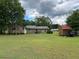 Large backyard showcases a wooden storage shed, a wooden deck, and ample green space for outdoor enjoyment at 483 Glen Terrace Rd, Auburn, GA 30011