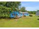 Charming blue home featuring a spacious backyard and patio with seating near mature trees at 483 Glen Terrace Rd, Auburn, GA 30011