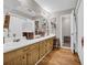 Bathroom featuring double vanity, wood floors, and linen closet at 483 Glen Terrace Rd, Auburn, GA 30011