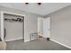 Gray bedroom with carpet, closet, and adjacent door at 483 Glen Terrace Rd, Auburn, GA 30011