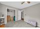Bright bedroom with a ceiling fan, closet, and gray carpet flooring at 483 Glen Terrace Rd, Auburn, GA 30011