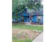 Charming blue house featuring a covered front porch and a well-maintained lawn at 483 Glen Terrace Rd, Auburn, GA 30011