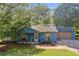 Charming blue single story home with a cozy front porch and manicured front yard at 483 Glen Terrace Rd, Auburn, GA 30011