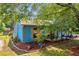 Quaint blue home with a charming porch, surrounded by trees and well-maintained landscaping at 483 Glen Terrace Rd, Auburn, GA 30011