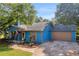 Inviting blue home with a well-kept lawn, charming front porch, and attached garage for convenience at 483 Glen Terrace Rd, Auburn, GA 30011