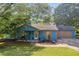 Charming single-story home with a well-manicured lawn, flower beds, and inviting porch at 483 Glen Terrace Rd, Auburn, GA 30011