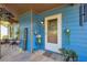 Inviting front porch with decorative plants, a sign, and comfortable seating enhancing curb appeal at 483 Glen Terrace Rd, Auburn, GA 30011