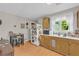Traditional kitchen featuring light wood floors, natural tone cabinetry, stainless steel fridge, and window views at 483 Glen Terrace Rd, Auburn, GA 30011