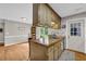 Spacious kitchen with wood counters, cabinets, stainless steel sink, and backyard access through French doors at 483 Glen Terrace Rd, Auburn, GA 30011